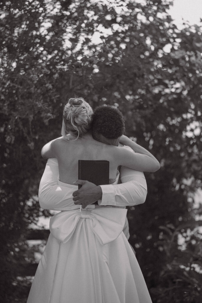 Black and white photo of the bride and groom hugging after their private vows from their Gansberg Rnach wedding.