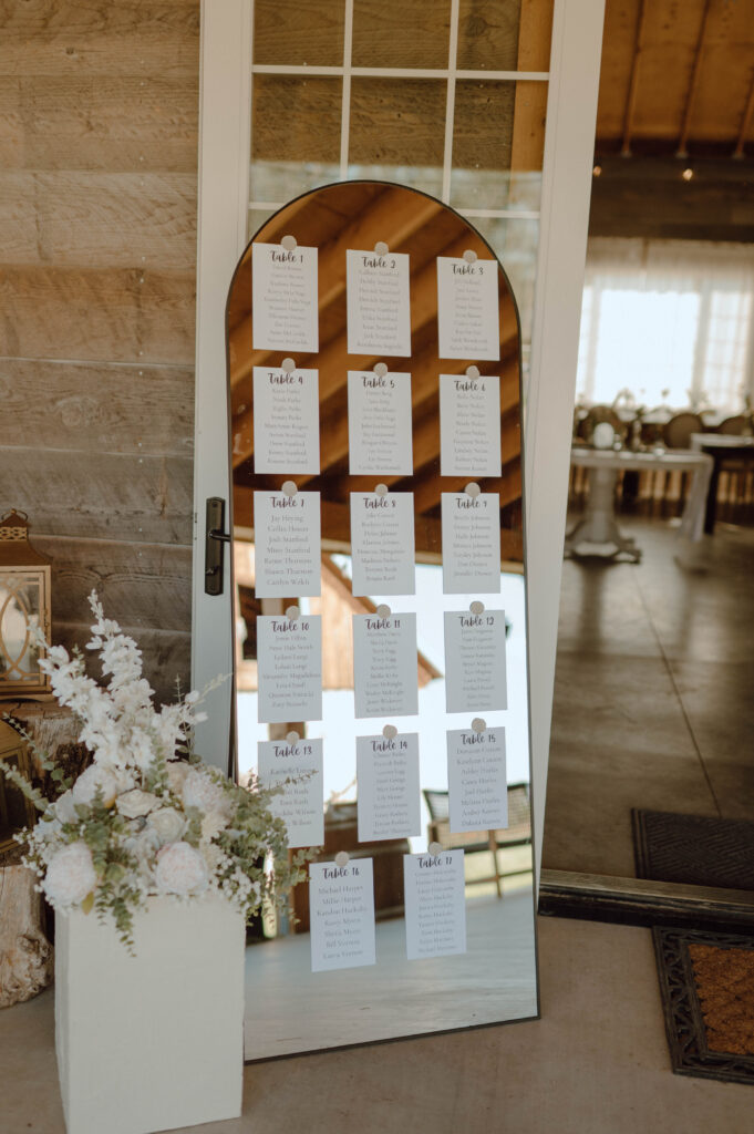 Mirror styled wedding reception seating chart.