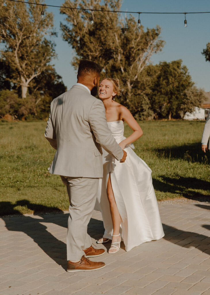 Bride and groom smiling during their first dance.