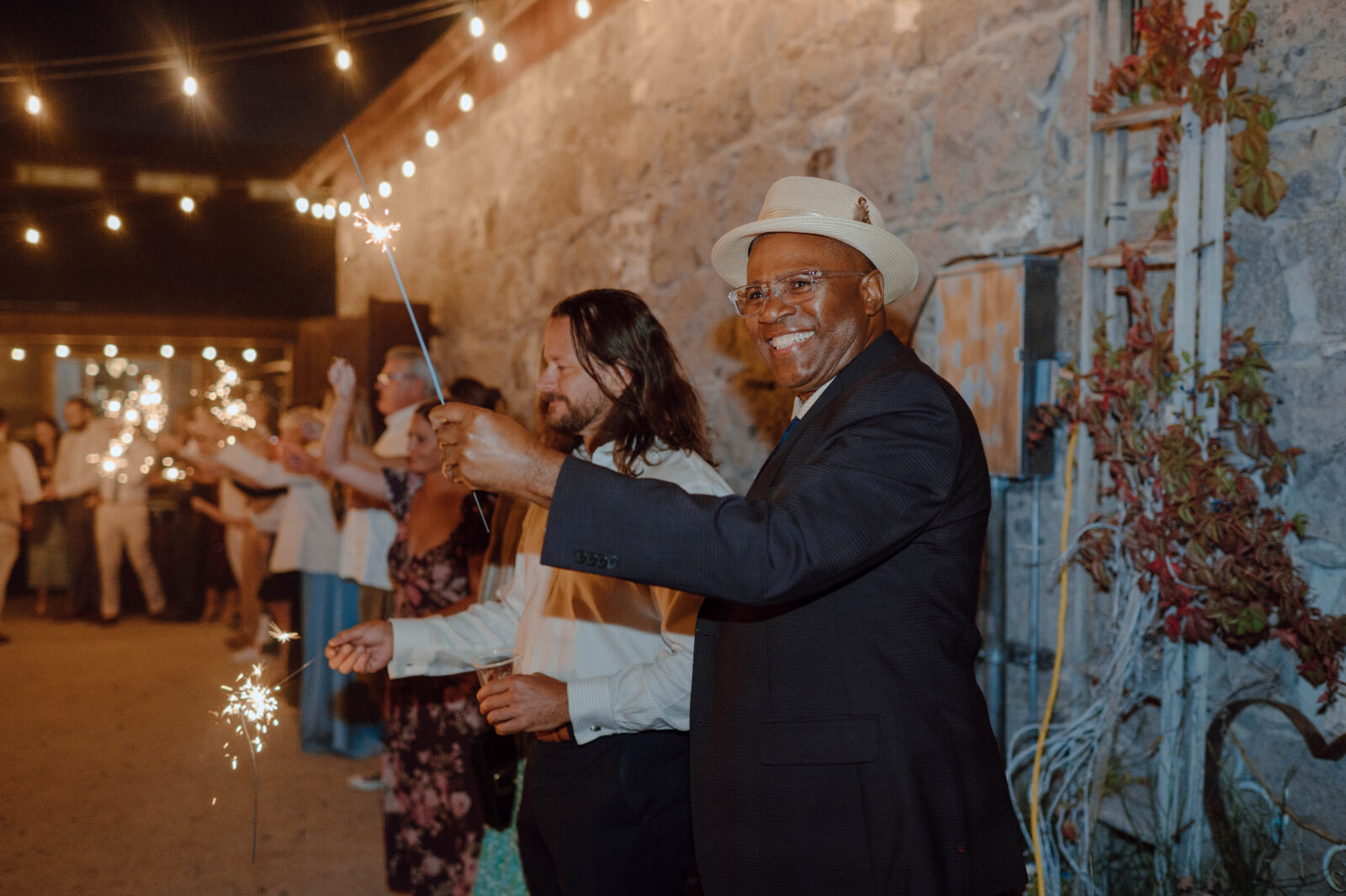 Guests holding sparklers during their sparkler wedding exit.