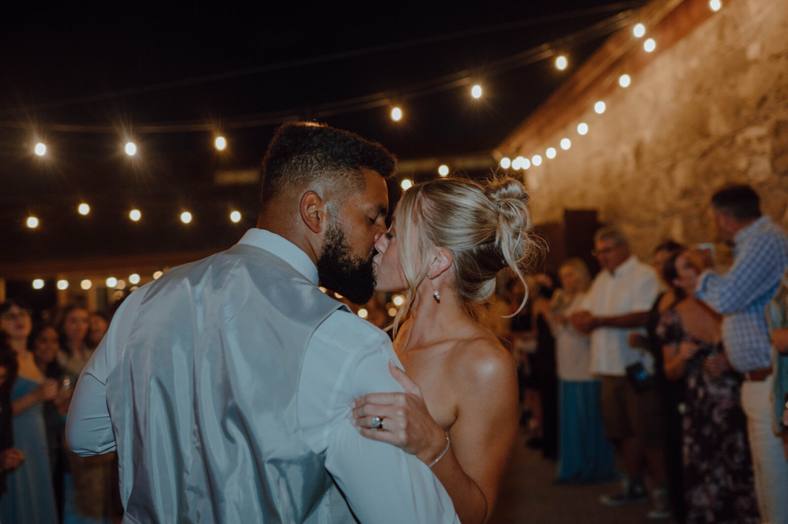 Bride and groom kissing after their sparkler wedding exit.
