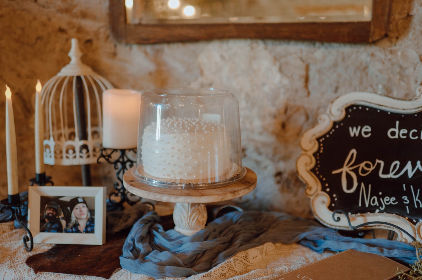 Small wedding cake on a dessert table.