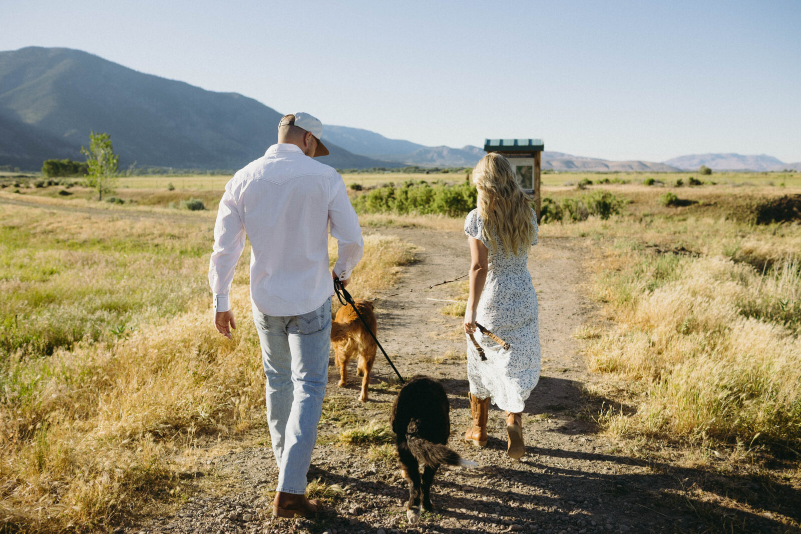 Candid photo of a couple walking a trail with their dogs in Genoa, Nevada. 