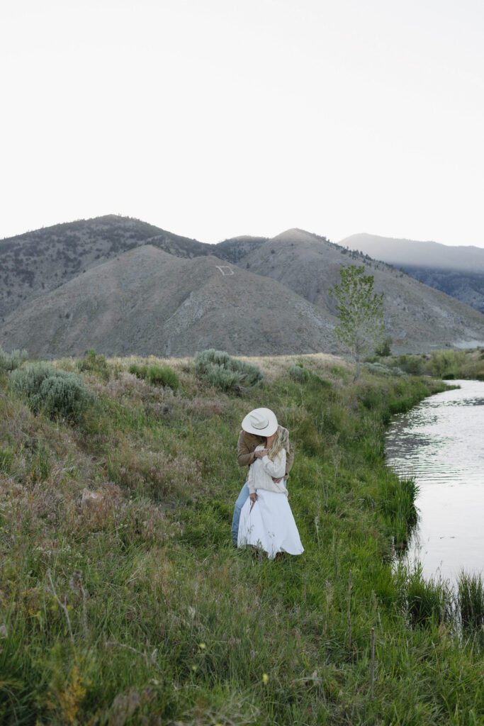 Couple kissing during their romantic mountain engagement photos at blu hour in Genoa Nevada. 