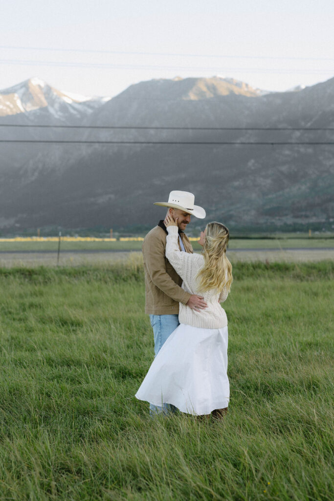 Couple embracing during their mountain engagement photos in Genoa Nevada with views of Jobs Peak in the background. 